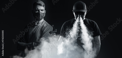 Two men with vape devices e...