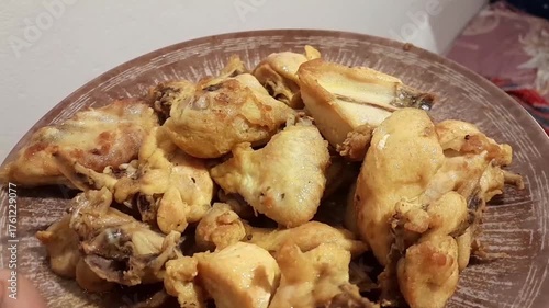 Fried chicken delicious cooked food video footage. Roasted chicken pieces in plate. Fried with oil, salt, red chilli powder, and Turmeric powder.