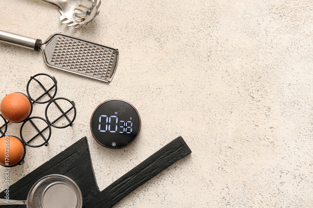 Naklejka premium Modern kitchen timer and utensils on light grunge background