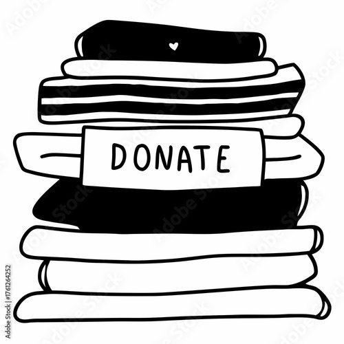 Stack of folded clothes labeled for donation in black and white  