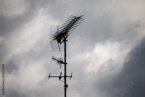 Принти на полотні A complex television antenna array is silhouetted against a cloudy, overcast sky