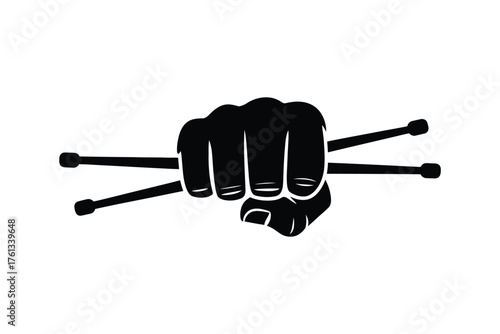 Fist crushing drumsticks in silhouette