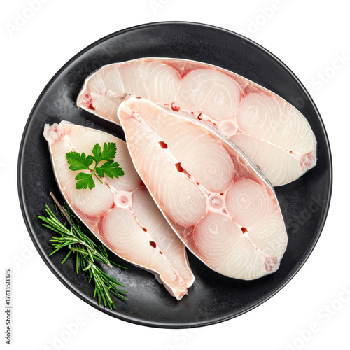 Freshly  Cold carp slices on black plate with rosemary and parsley isolated white background