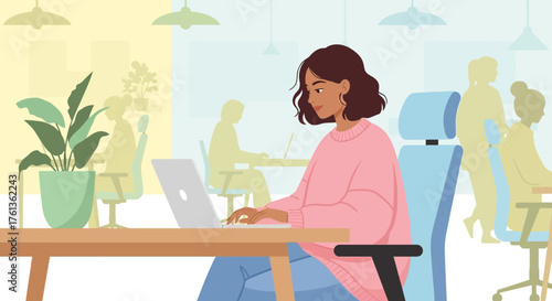 A woman working on her laptop in a modern office setting, surrounded by colleagues and plants