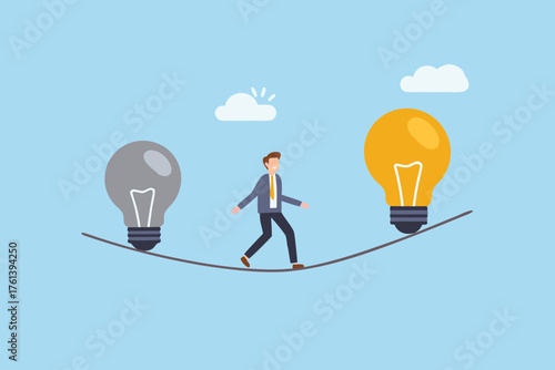 Businessman walking a tightrope between a gray and a glowing yellow light bulb representing ideas