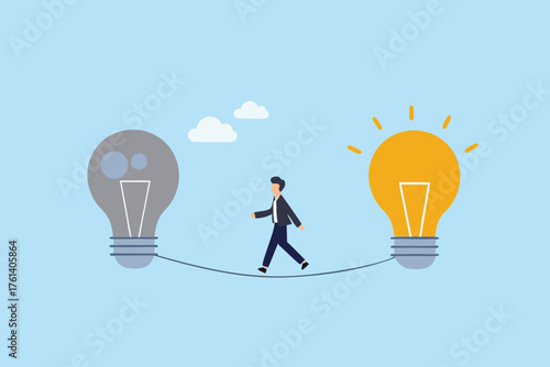 Businessman walking a tightrope between a dark and a bright idea lightbulb symbolizing innovation and creativity