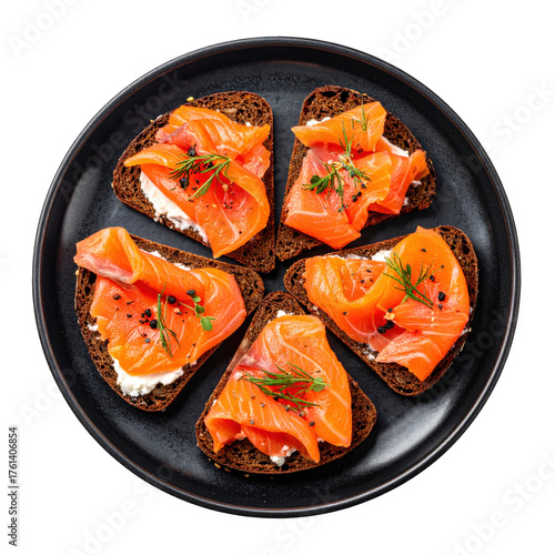 Delicious smoked salmon on rye appetizers on dark rye bread garnished with dill isolated white background