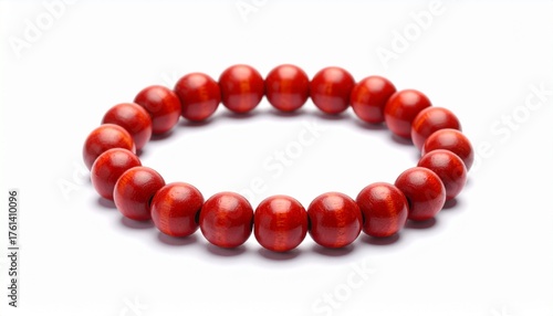 Close-up of a red wooden bead bracelet on a white background. 
