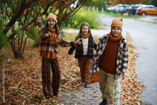 Autumn Adventure: Kids in Warm Clothing Enjoying a Colorful Walk in the Park