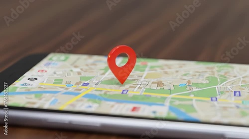 A smartphone displaying a map with a red location pin.