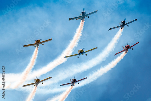 Photography Acrobat planes fly in formation with smoke trailing behind them