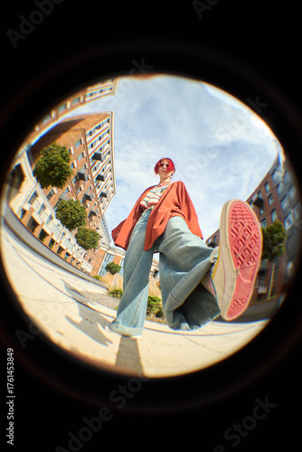 Принти на полотні Fish eye view of Caucasian young woman with short pink hair standing outdoors in