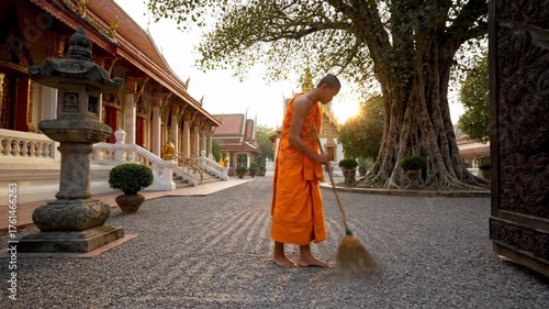 Monk Sweeping Path in Serene Monastery at Sunrise in Thailand