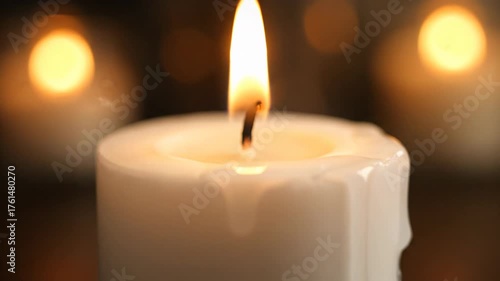 Serene Close-Up of a Glowing Candle Flame with Melting Wax and Warm Bokeh Background