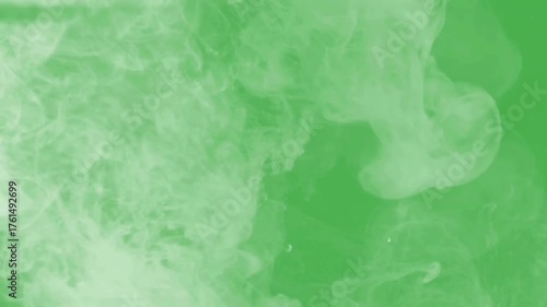 Abstract green smoke swirls and wisps on a green background 