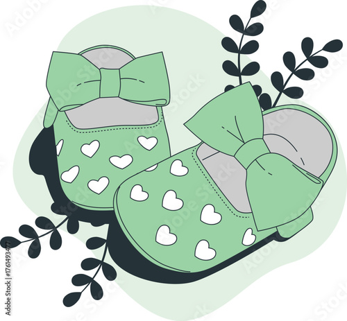 Cute green baby booties with white hearts and bows surrounded by leaves Keywords: baby shoes, baby booties, infant footwear, baby fashion, newborn, baby shower, pregnancy, maternity, cute