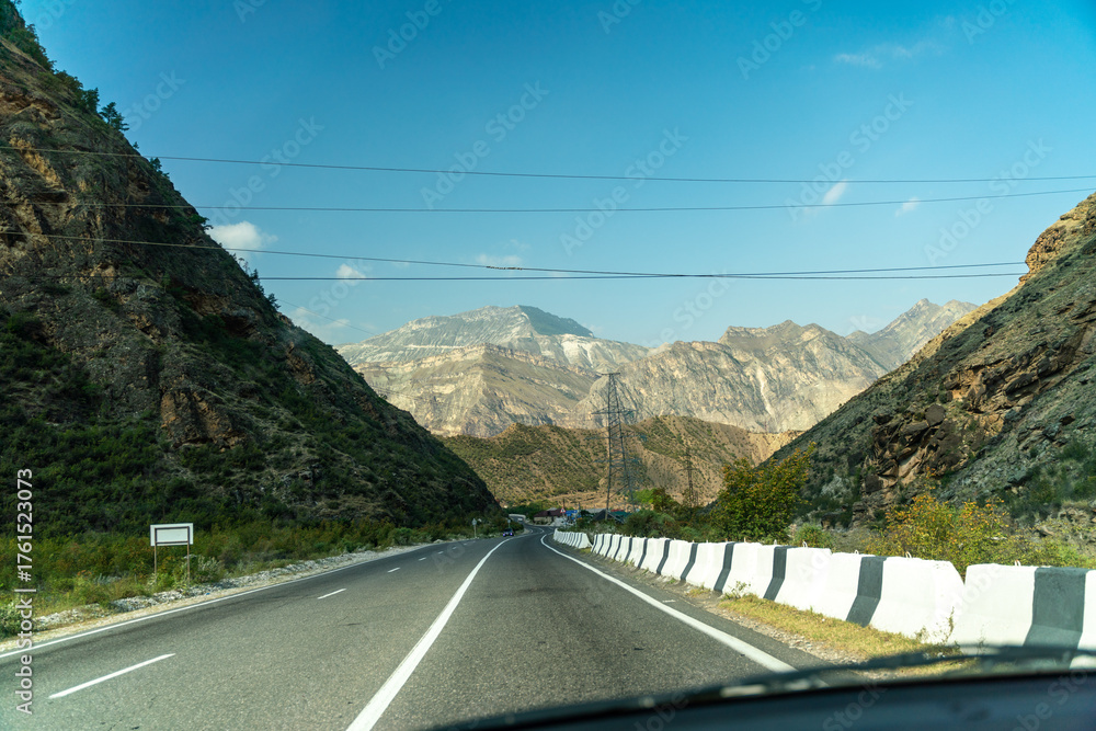 Obraz premium View from the car of an asphalt road in the mountainous area of Dagestan