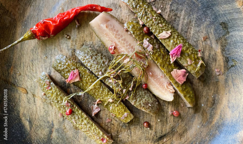 Obraz na plátně Crunchy pickled cucumbers and fiery chili embrace mystical rose petals on rustic