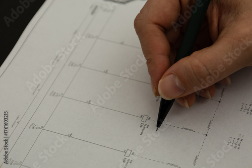 Hand drawing on technical blueprint with pen
