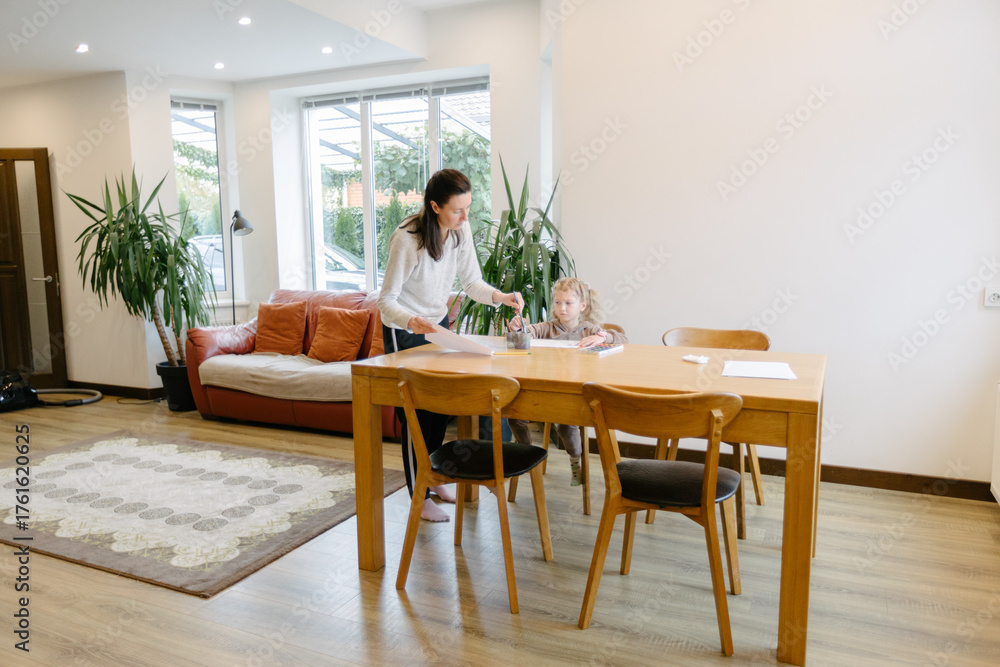 Fototapeta premium Woman and a kid drawing indoors