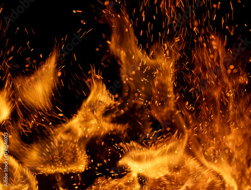A close up of a fire with lots of sparks flying out of it