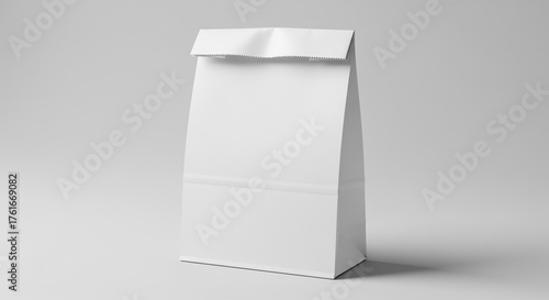 White paper bag standing upright on a neutral gray background, showing a clean and simple design with a folded top.