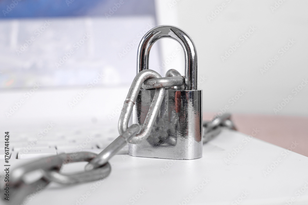 Fototapeta premium Strong Padlock And Chain On Laptop Keyboard