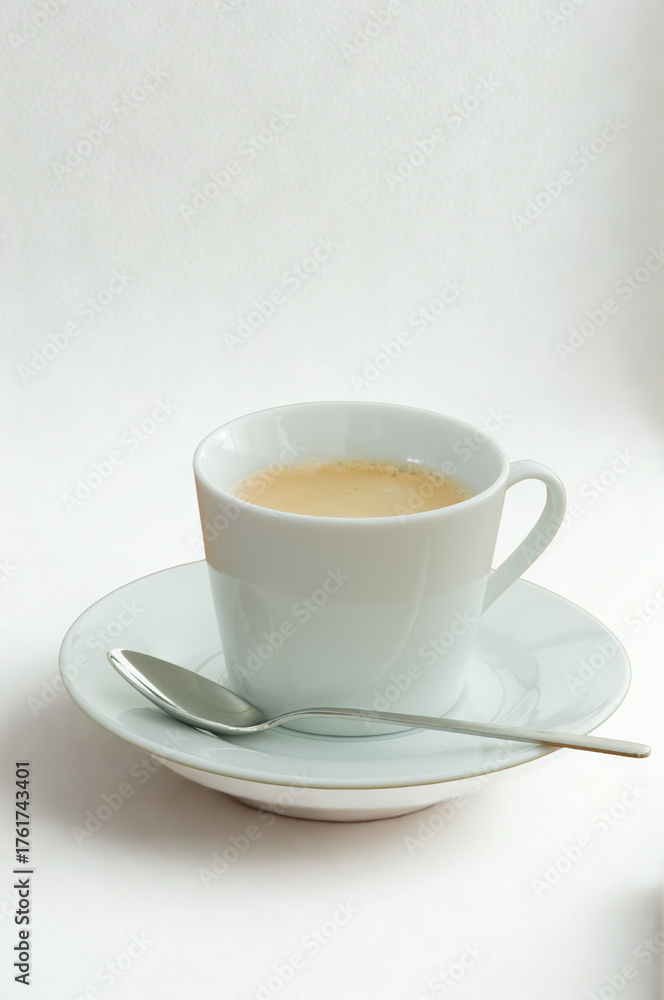 Fototapeta premium A cup of tea with a spoon on a saucer