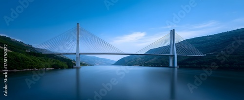 Panel kuchenny z motywem the modern suspension bridge stretching over a broad flowing river waterway