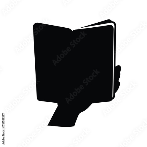 Silhouette of a hand holding an open book suggesting knowledge and reading