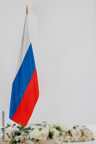 Russia flag and flowers on a white background with space for text.