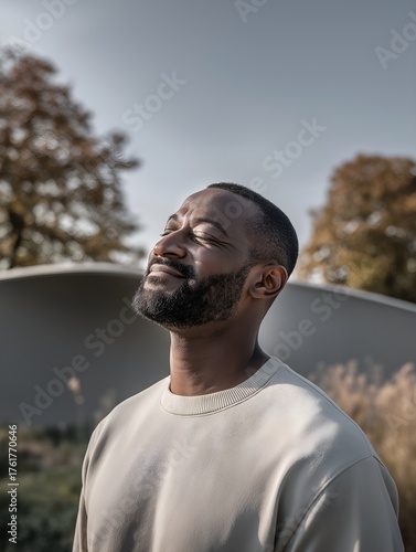 Portrait of a man smiling in warm sunlight, peaceful mood