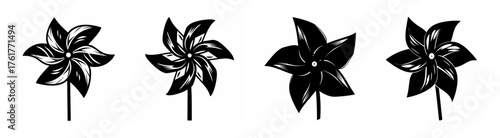 Four diverse black pinwheels displayed in a row on a capturing movement and playfulness