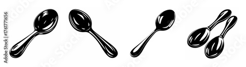 Collection of four gleaming metal spoons arranged at various angles on a clean white backdrop suitable for design projects