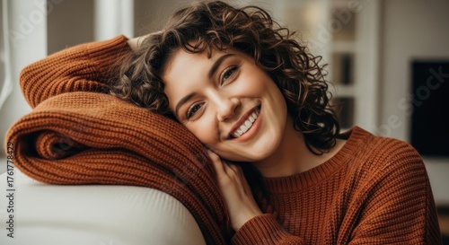 Woman With Curly Hair Resting Head On Sweater Smiling