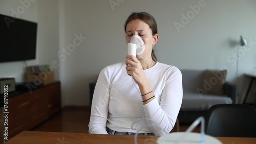 Woman coughing while using nebulizer