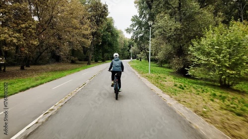 Wallpaper Mural 4K footage of a woman riding a bicycle along autumn forest path on Ada Ciganlija Island in Belgrade, Serbia. Rear view. Peaceful atmosphere and active outdoor lifestyle Torontodigital.ca