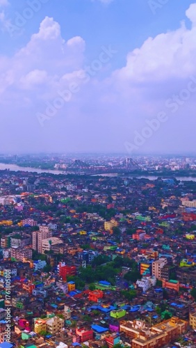 Vertical Cinematic Aerial Drone Shot of Kolkata City with Howrah Bridge and Kolkata Skyline Over Hooghly River