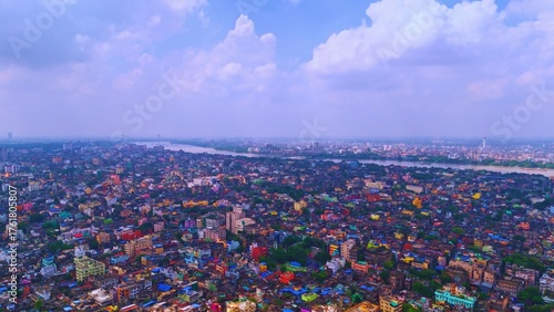Cinematic aerial drone footage capturing the stunning view of Kolkata City with the iconic Howrah Bridge spanning the Hooghly River