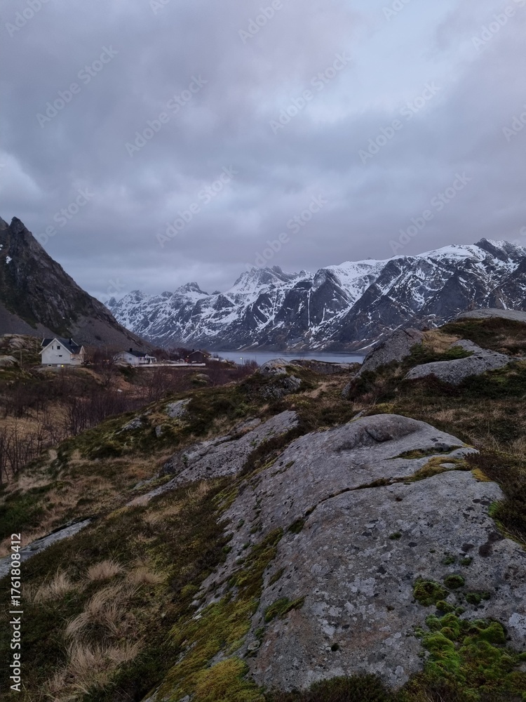Fototapeta premium Norwegian traditional fishermans village named Sund located on Lofoten islands between the picturesque snow covered mountains and fjords