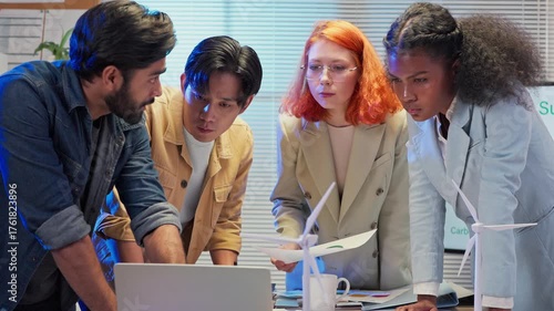 Multi-ethnic business professionals collaborate in a modern office at night, engaging in an agile transformation meeting focused on digital innovation, business shift strategy, data-driven decision-ma