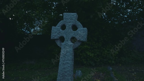 Gravestone in churchyard at dusk