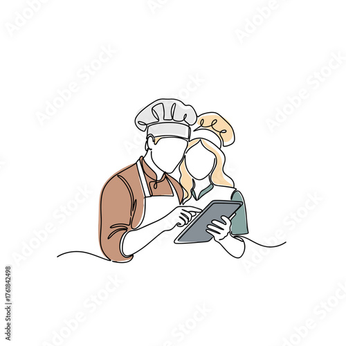 Couple cooking together while looking at recipe tablet for unposed leisure scenes  