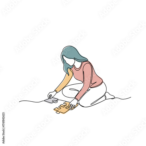 Woman assembling puzzle on the floor in concept of unposed leisure scenes  