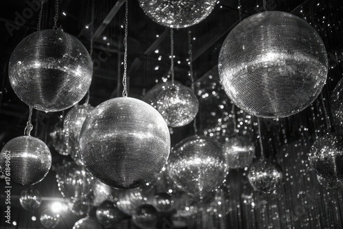 Monochrome scene with numerous sparkling, reflective spheres hanging from above