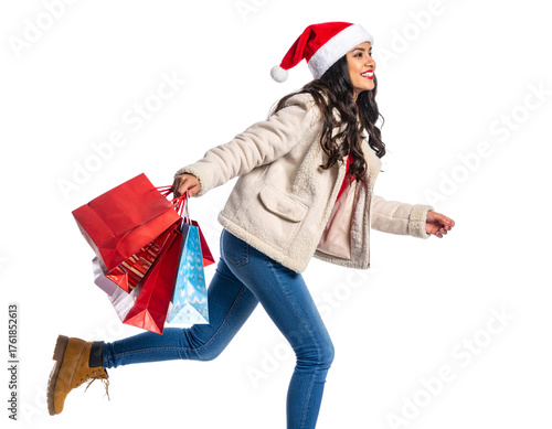 Festive Shopper Woman in Santa Hat Walking with Holiday Gift Bags, Side Angle, Isolated on White Background
