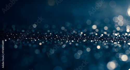 Elegant dark blue abstract background with a mesmerizing stream of silver glitter creating a magical and festive atmosphere