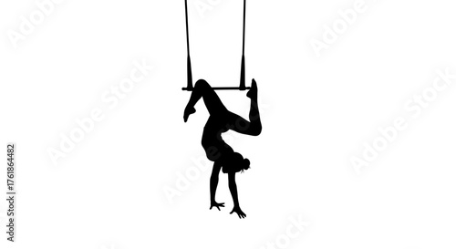 Dynamic silhouette of acrobat performing upside down on trapeze, evoking strength and control for fitness brands and artistic projects