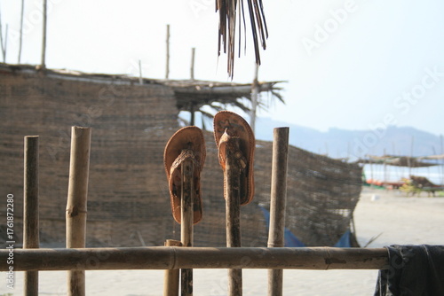 Slippers are hanging on the fence
