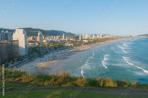 Top-down view from Mirante da Campina, showing Enseada Beach in Guaruja. The landscape unites the ocean and the city on a sunny day. Sao Paulo coast, tourism, and tropical travel.